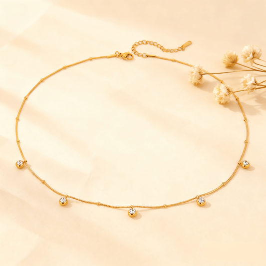 Luminova Dainty Gold Drop Necklace with a teardrop pendant, isolated on a white background.