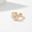 White enamel flower ring with gold rim and crystal center adjustable band.