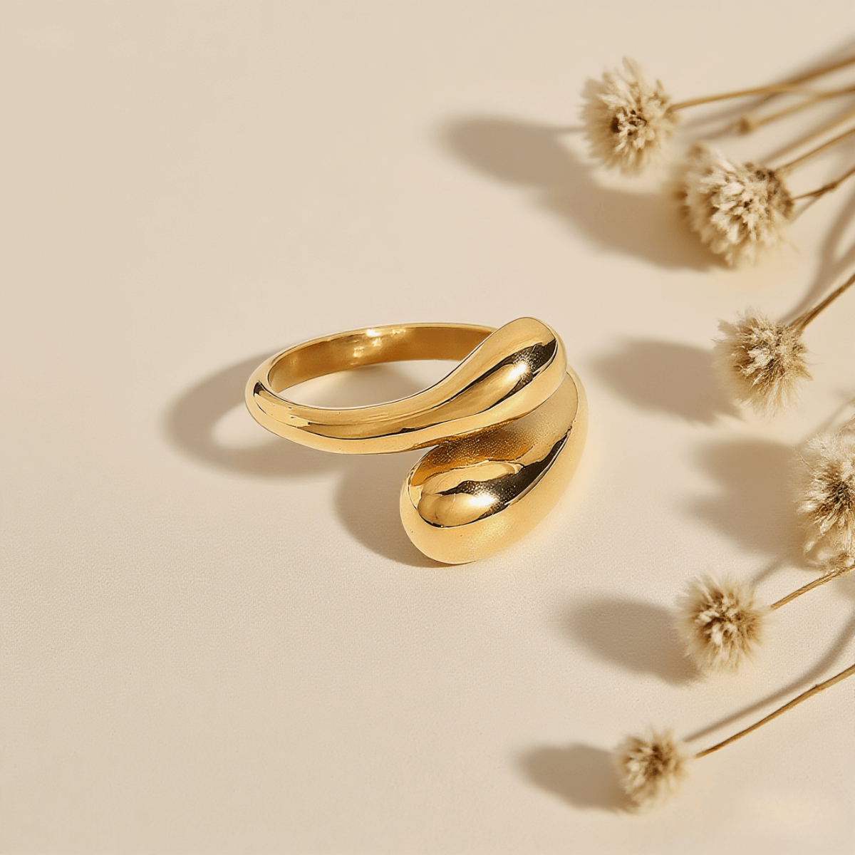 Fluid Pebble Ring — sculptural pebble wrap ring in gold/silver finish, polished and elegant.