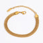 Gold mesh bracelet flat woven stainless steel chain on white background.