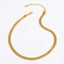 Gold mesh chain necklace flat flexible stainless steel choker on white background.