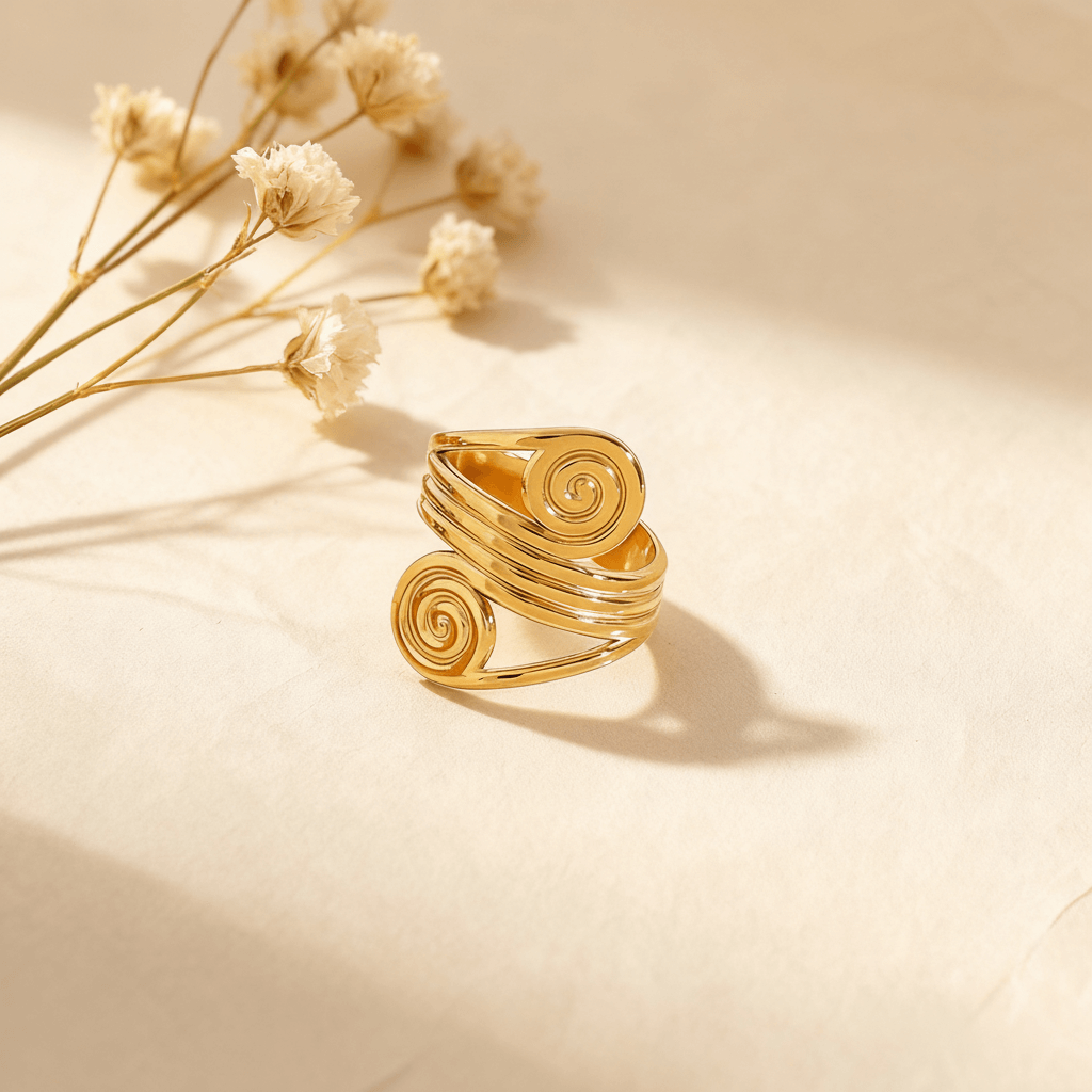 An extreme close-up macro shot of one of the spiral ends of The Oracle Ring. The image details the perfectly coiled lines and the high-polish finish that reflects light, resembling a golden fossil or a sacred labyrinth.