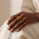 Woman wearing vintage gold gemstone ring with tiger's eye stone fall fashion.