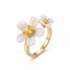 Adjustable gold ring with white enamel flowers and yellow citrine crystal stones.