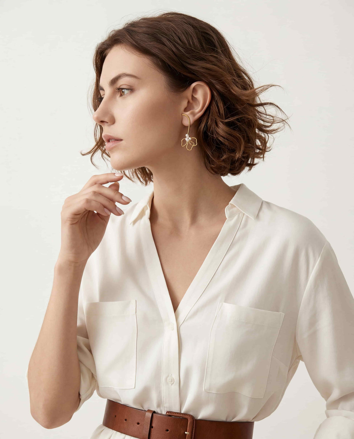 Elegant woman styling statement wire flower earrings French chic aesthetic everyday jewelry.
