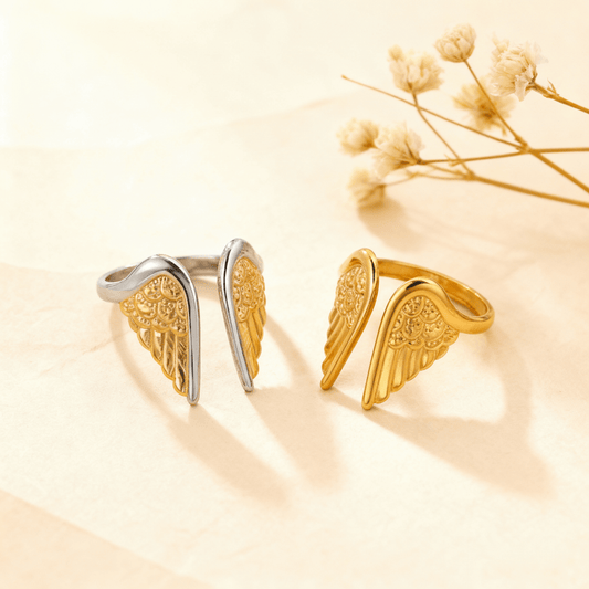 The Seraphina Ring shown in both two-tone (silver and gold) and all-gold finishes, styled on a light, textured background with delicate dried flowers.