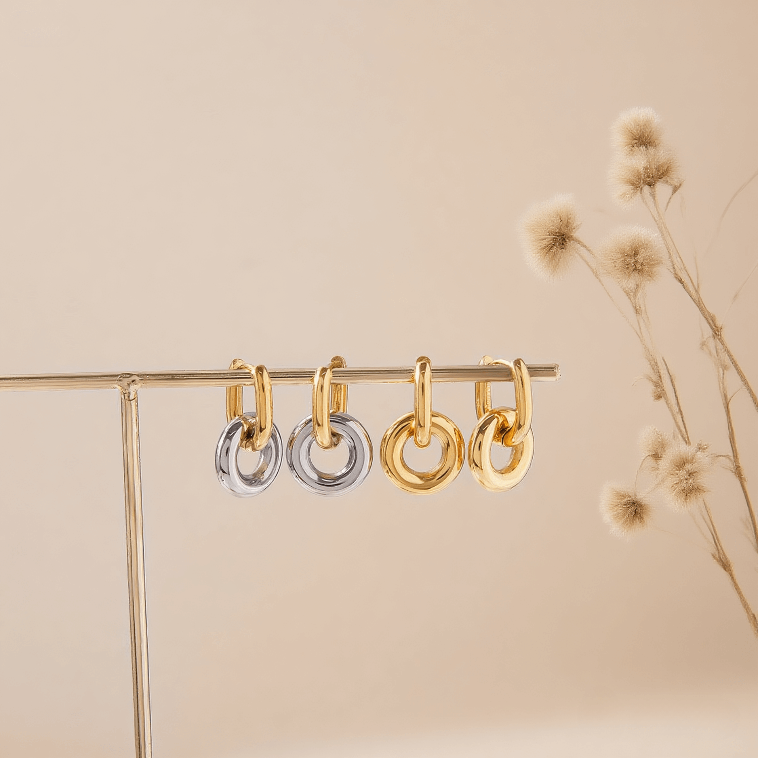 Chunky Twist Knot Hoop Earrings in 18K Gold Plated Brass, isolated on a white gold background.