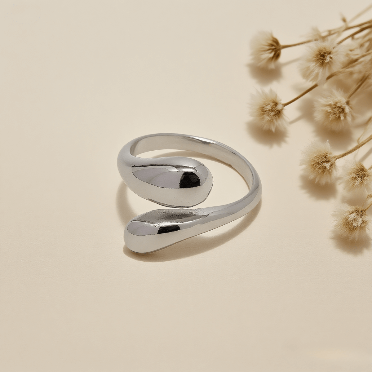 Fluid Pebble Ring — sculptural pebble wrap ring in gold/silver finish, polished and elegant.