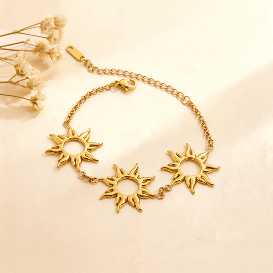 Luminova Radiant Sun Charm Bracelet with detailed sunburst pendant on a clean gold white background.