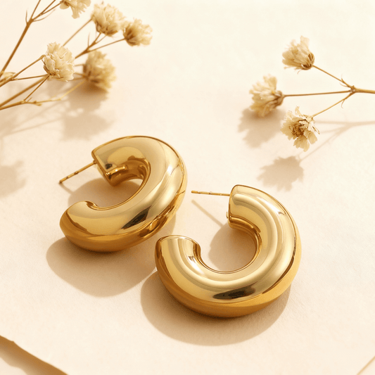 Close-up of the gold Cloud Hoops, showing their puffy, dome-like shape, hollow construction, and high-polish finish.