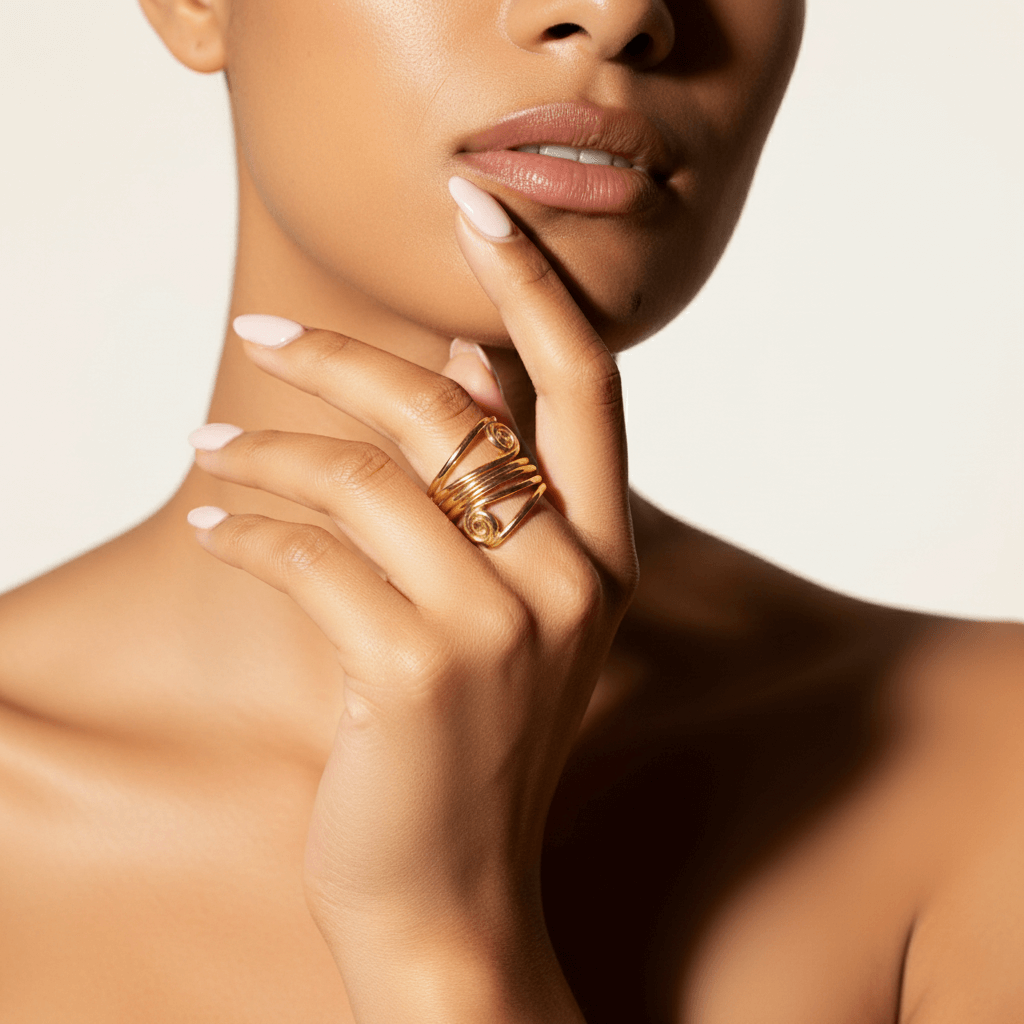 A powerful shot of a model's hands clasped together, with The Oracle Ring prominently featured. Her confident posture and the ring's armor-like presence combine to create an image of undeniable self-assurance.