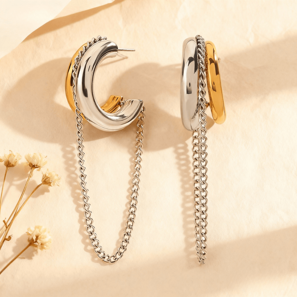 Luxe Layered Chain Hoops in two-tone gold and silver with a chunky C-shape and a dangling silver chain.