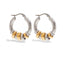Mixed metal two-tone gold and silver stacked hoop earrings waterproof jewelry.