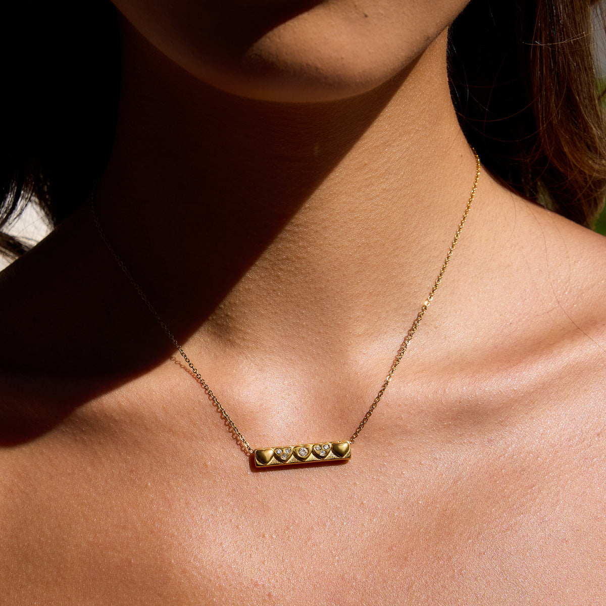 Heartline Bar Necklace — gold bar pendant with heart details and stones, romantic and elegant necklace.