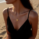 Vintage Heart Medallion Necklace — heart-shaped medallion pendant on twisted gold chain, romantic and vintage style.