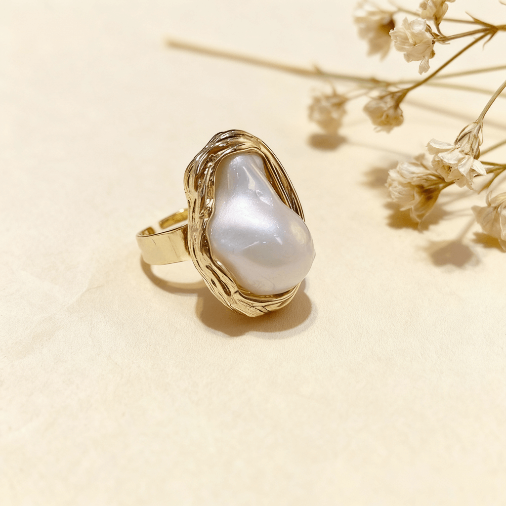 Top-down view of The Theia baroque pearl ring, highlighting the unique, irregular shape and iridescent luster of the central pearl."