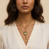 A beautiful close-up of a model wearing The Artemis Lariat, highlighting the vibrant leopard print heart against her skin with a classic white shirt.