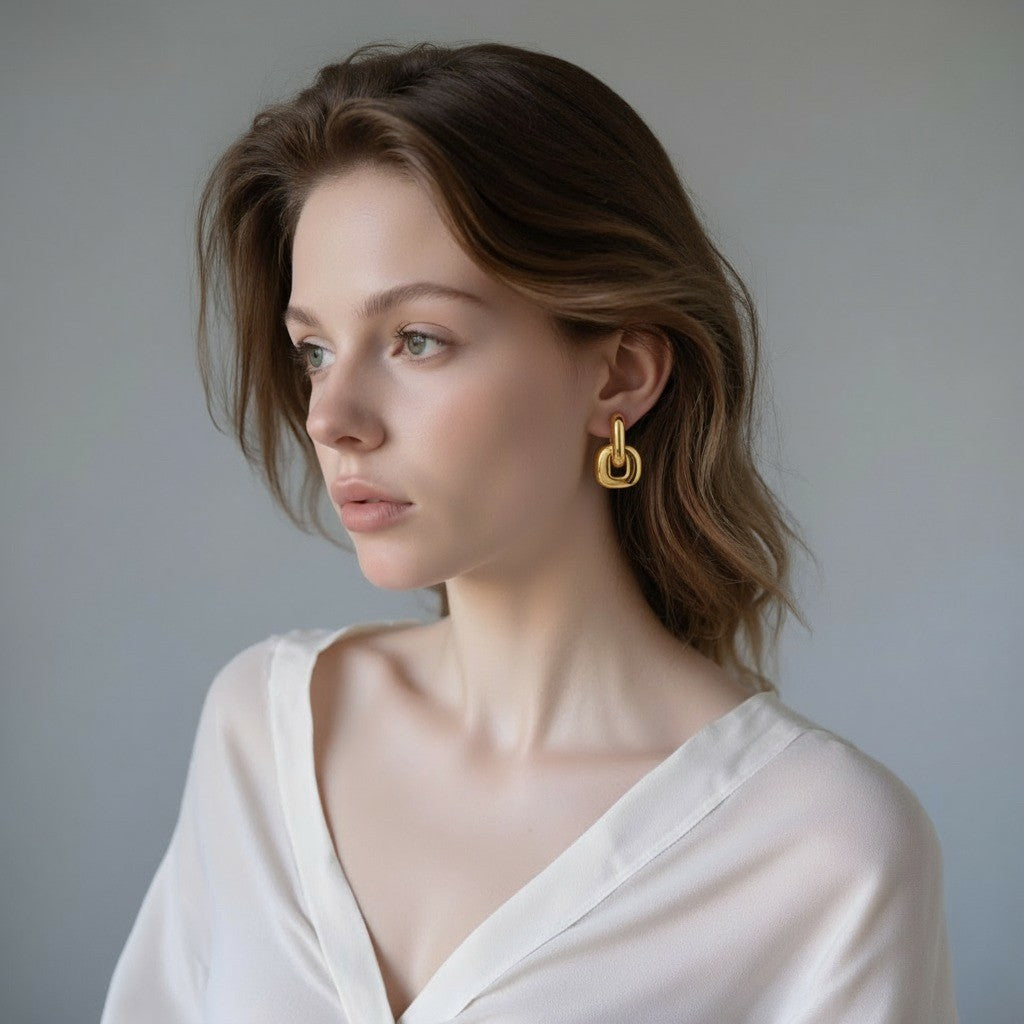 Urban Link Earrings — bold link earrings in polished gold/dual-tone on neutral background, modern statement jewelry.
