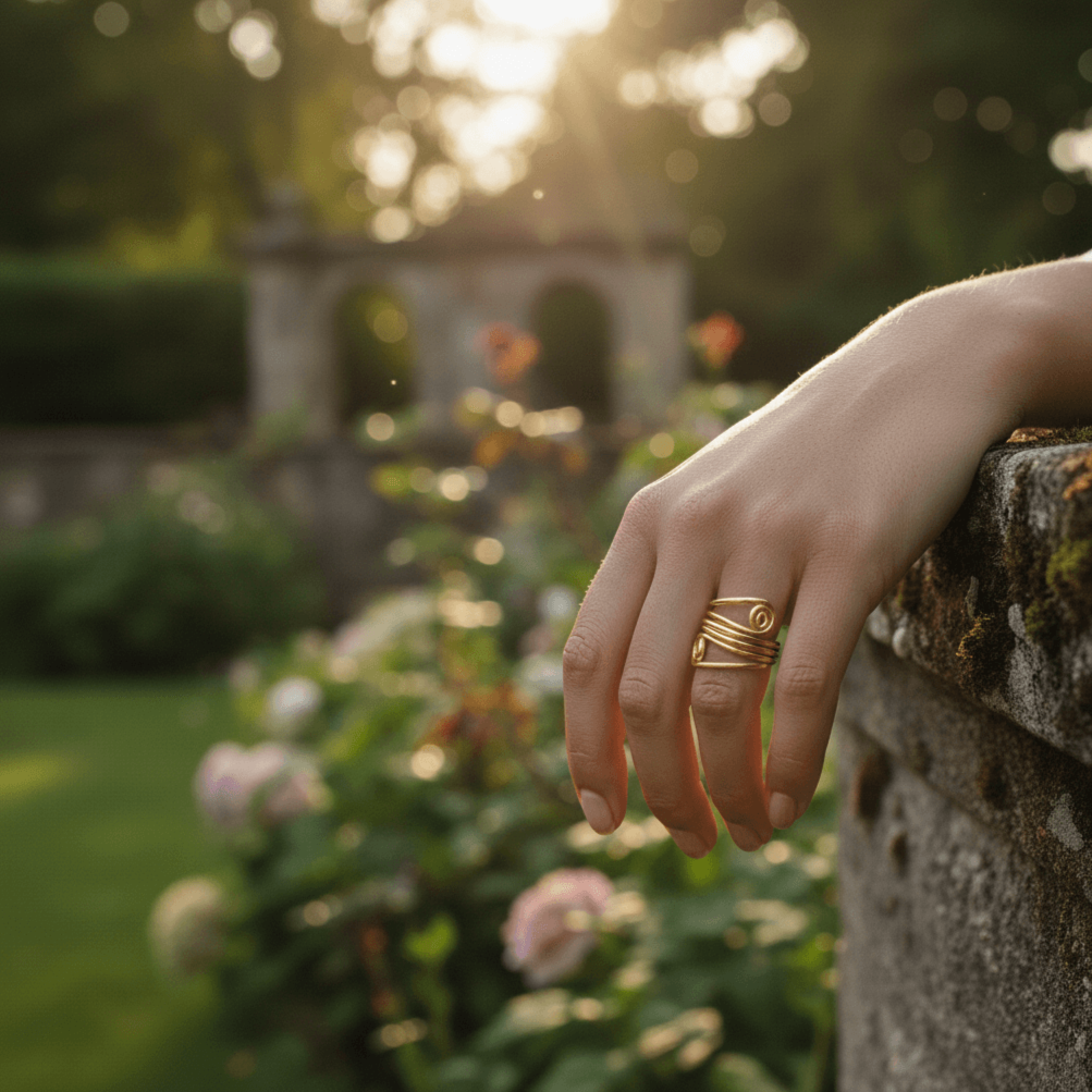 A model's hand, adorned with The Oracle Ring on the middle finger, gently holding a raw quartz crystal. The image evokes a sense of spiritual power, mysticism, and a connection to the earth.
