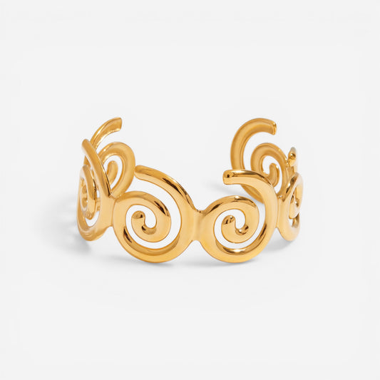 Abstract spiral wave cuff bracelet gold stainless steel cutout design.