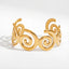 Abstract spiral wave cuff bracelet gold stainless steel cutout design.