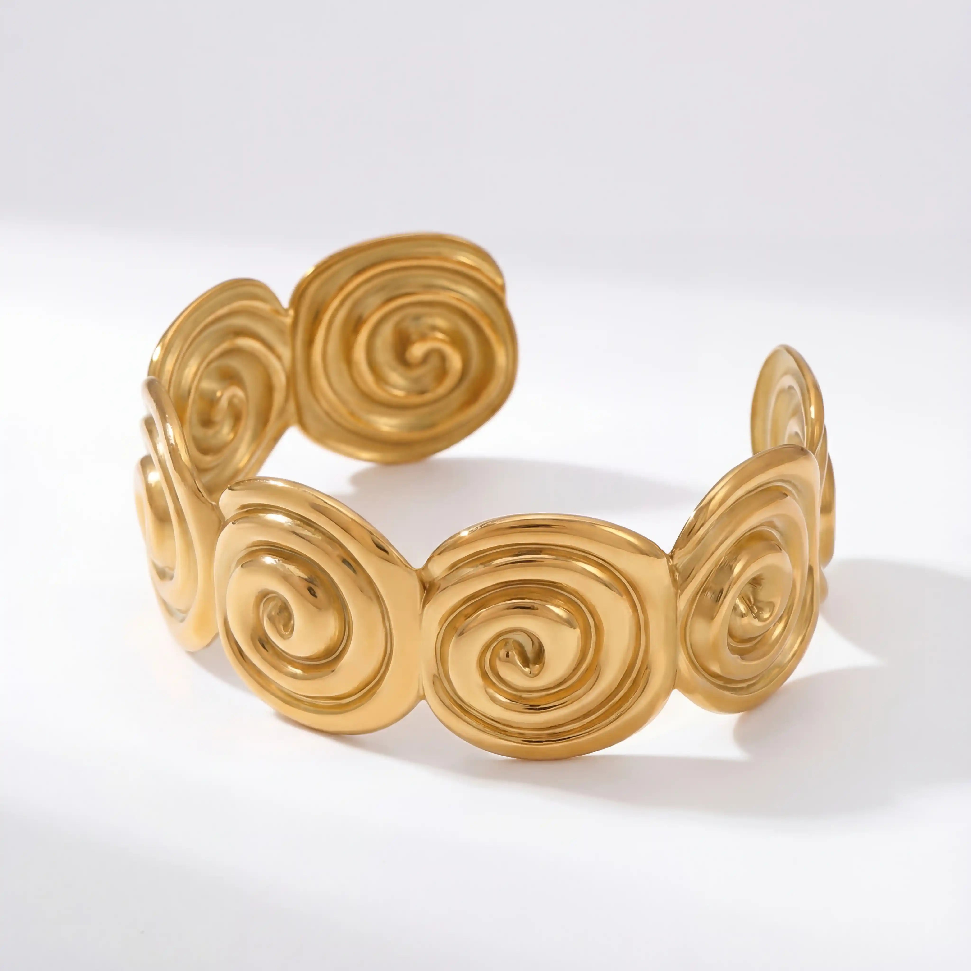 Side view of adjustable wide gold cuff with cutout wave pattern.