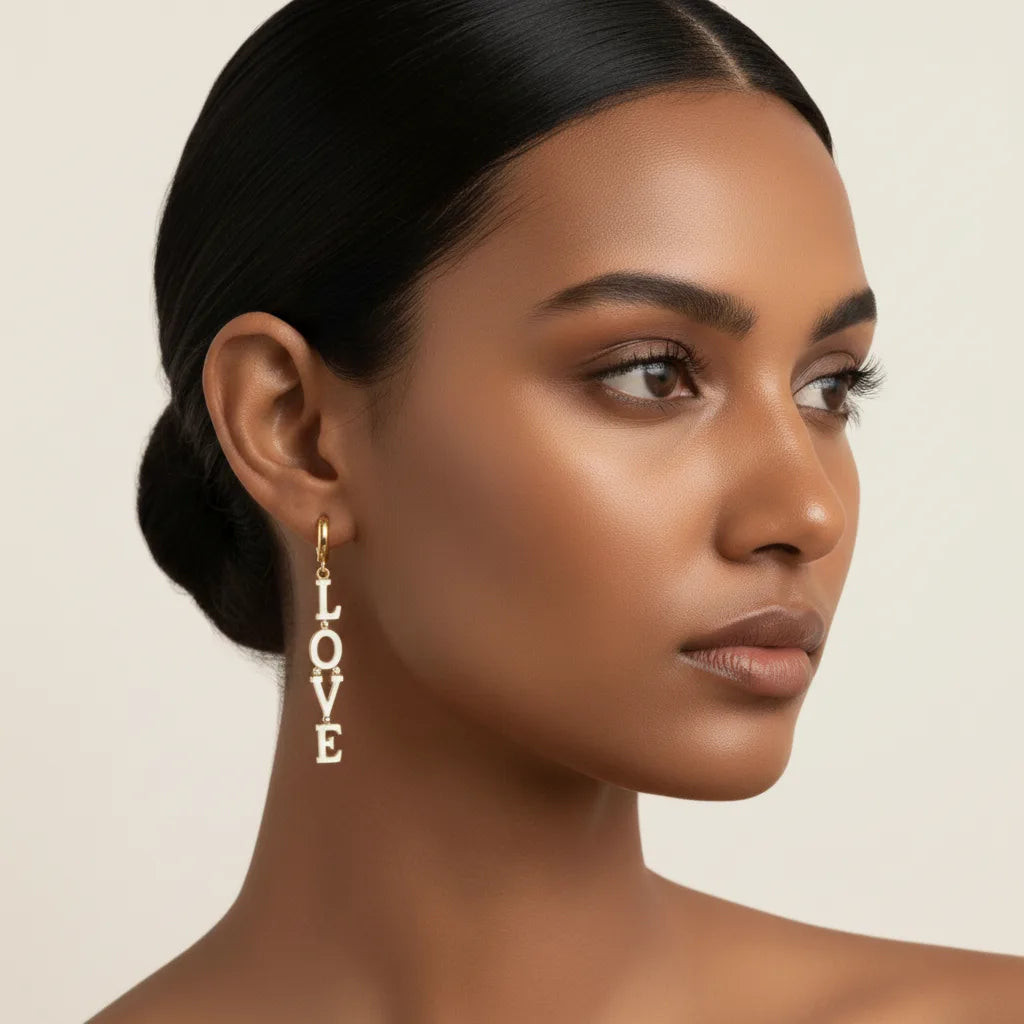 Side view of a model with an elegant updo, wearing The Amor Earrings to demonstrate their sophisticated drop length and modern style