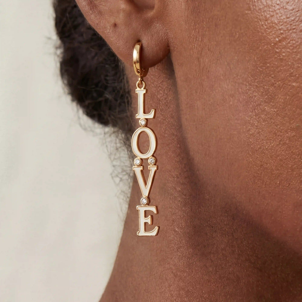 Close up of woman with dark skin wearing gold Pythia cuff bracelet with sculptural fluid design.