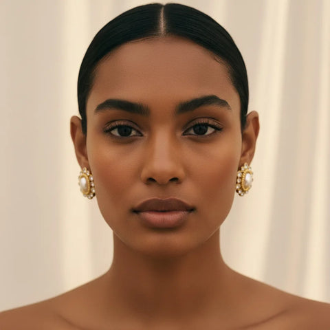 A beautiful front-facing portrait of a model, showing how The Antoinette halo stud earrings elegantly frame the face for a regal, sophisticated look.