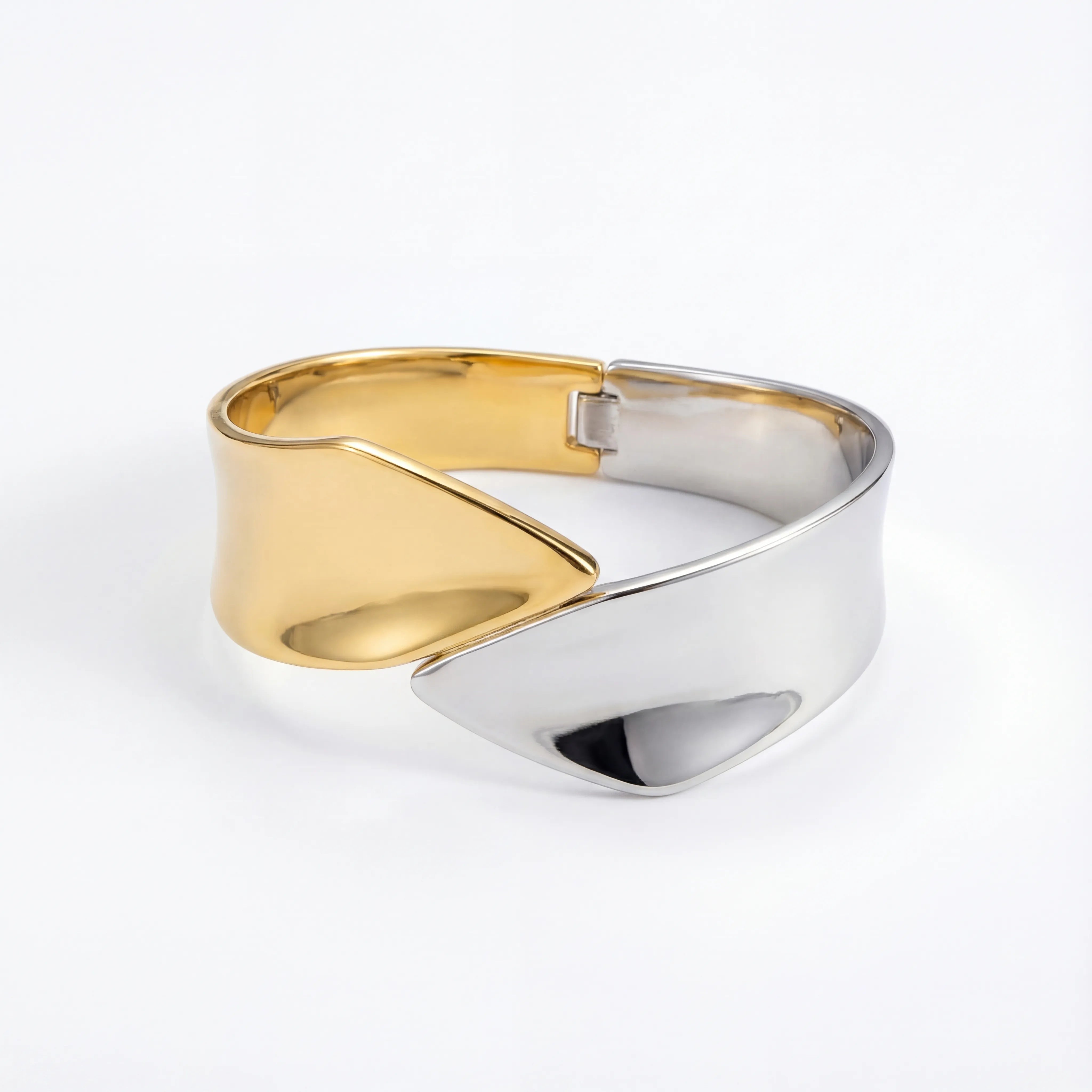 Sculptural two-tone open cuff bracelet modern design stainless steel.