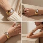 Lifestyle styling of chunky two-tone cuff bracelet on woman with beige sweater.
