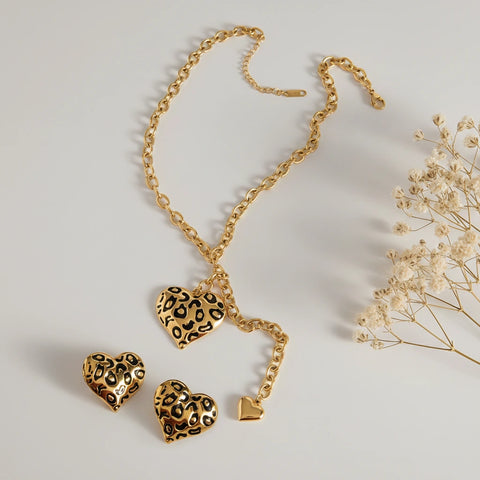 An artistic flat lay of The Artemis Lariat and matching earrings, showcasing the full, fierce collection for a powerful, coordinated look