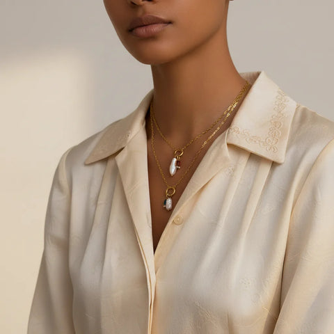 The Astoria Necklace resting on a model's collarbone with a beautiful silk blouse, highlighting its perfect length and sophisticated charm.