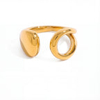 Asymmetrical teardrop open ring gold stainless steel liquid metal design.