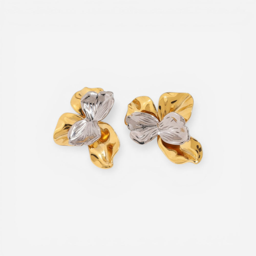 Pair of sculptural earrings with crushed gold metal and clear ice-like resin stone.
