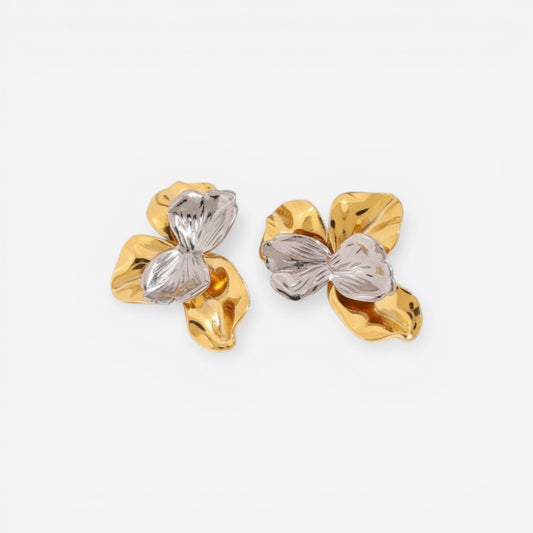 Pair of sculptural earrings with crushed gold metal and clear ice-like resin stone.