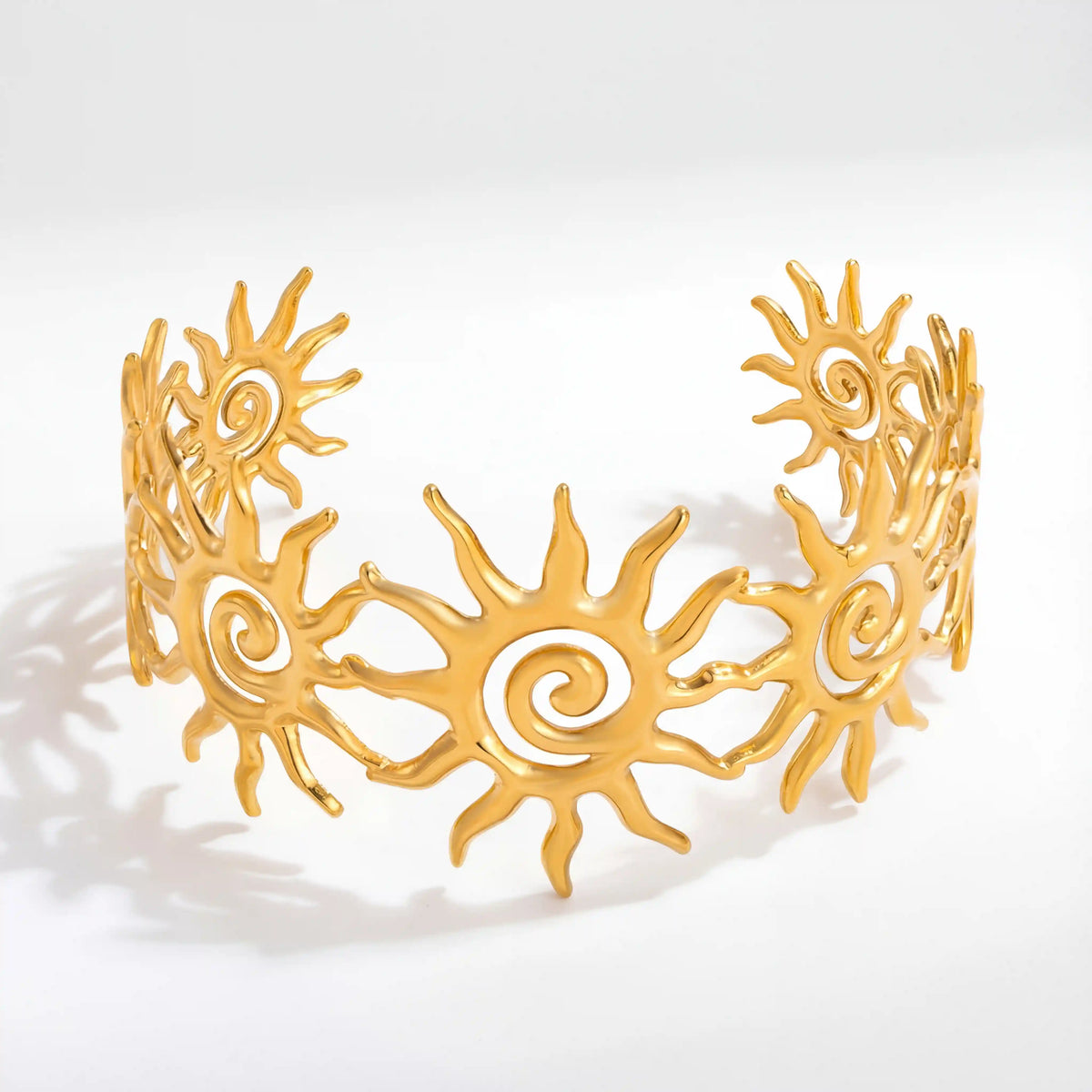 Gold celestial sun open cuff bracelet with triple spiral cutout design stainless steel.