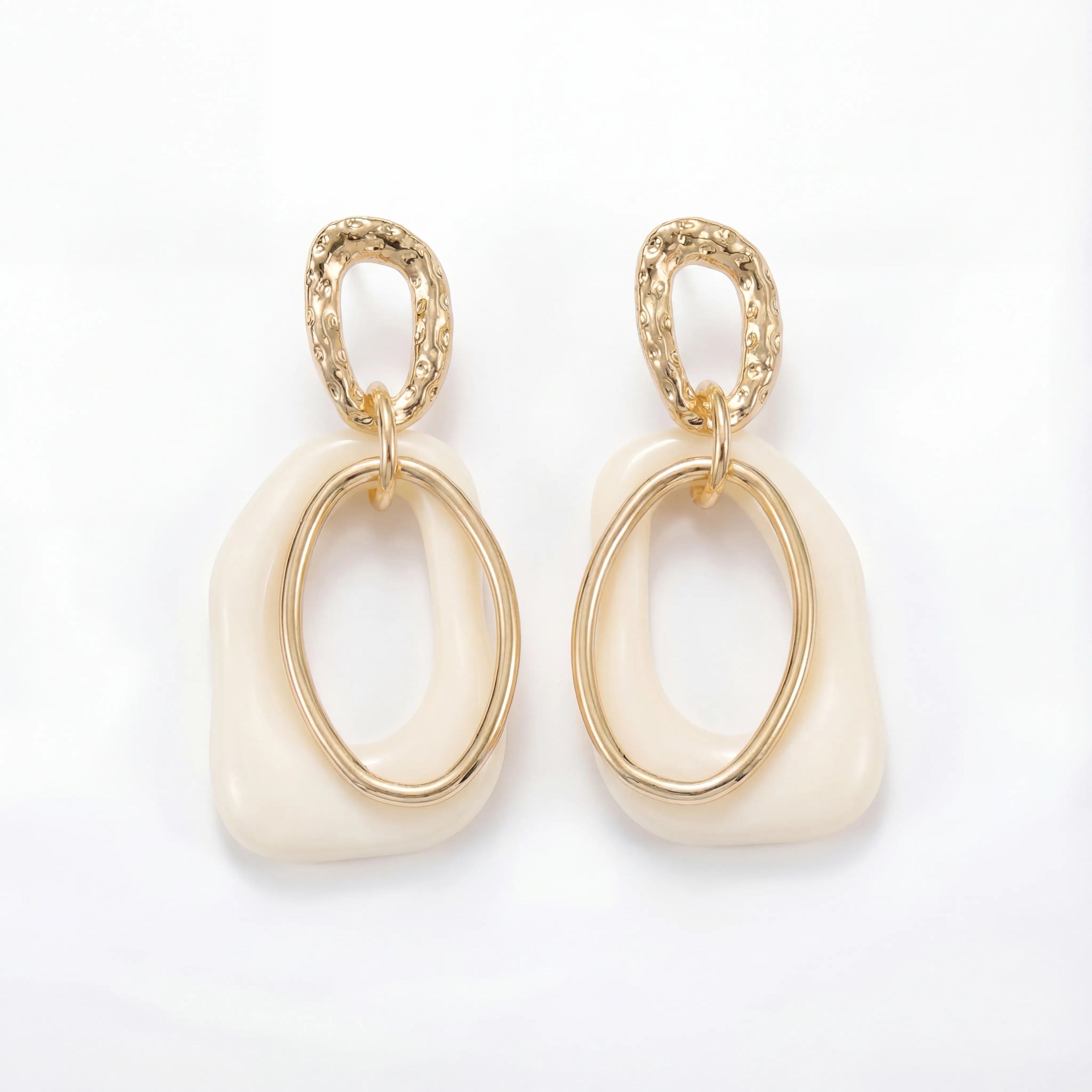 Cream enamel abstract drop earrings with textured gold stainless steel finish.