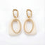 Cream enamel abstract drop earrings with textured gold stainless steel finish.