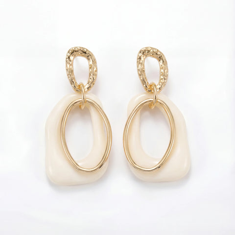 Cream enamel abstract drop earrings with textured gold stainless steel finish.