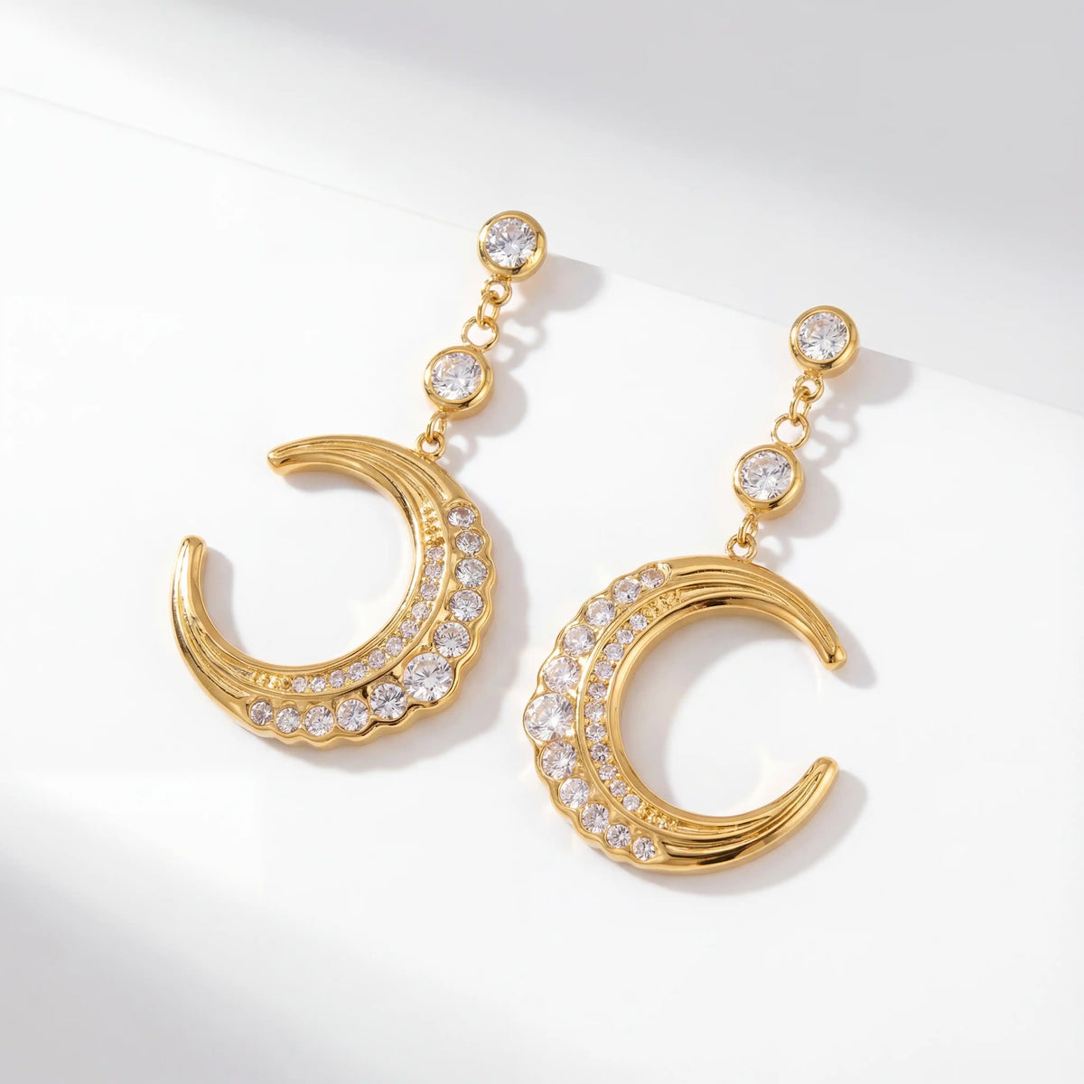 Pair of gold moon drop earrings with cubic zirconia waterproof stainless steel.