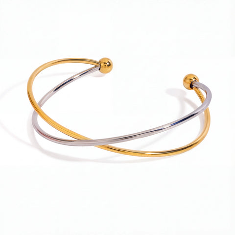 Mixed metal two-tone crossover bangle gold and silver wire bracelet.