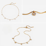 Aesthetic product photography of delicate gold drop necklace details on white background.