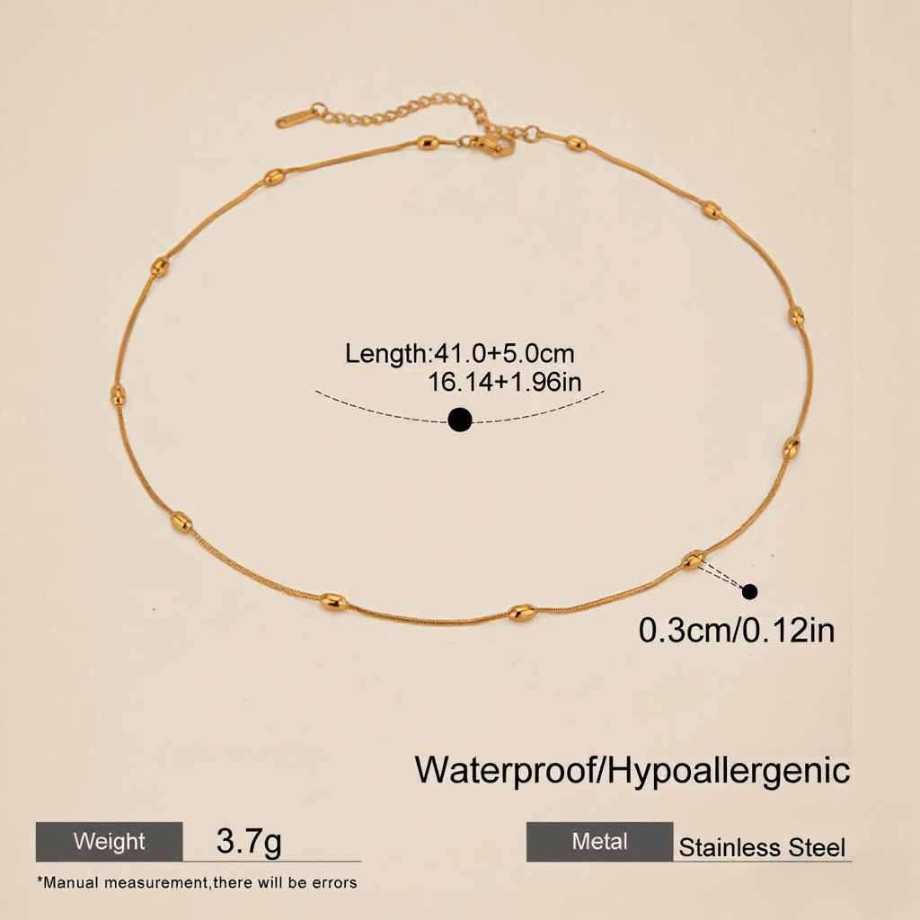 Extreme close-up macro shot of the delicate gold beads on the chain, highlighting texture and craftsmanship.