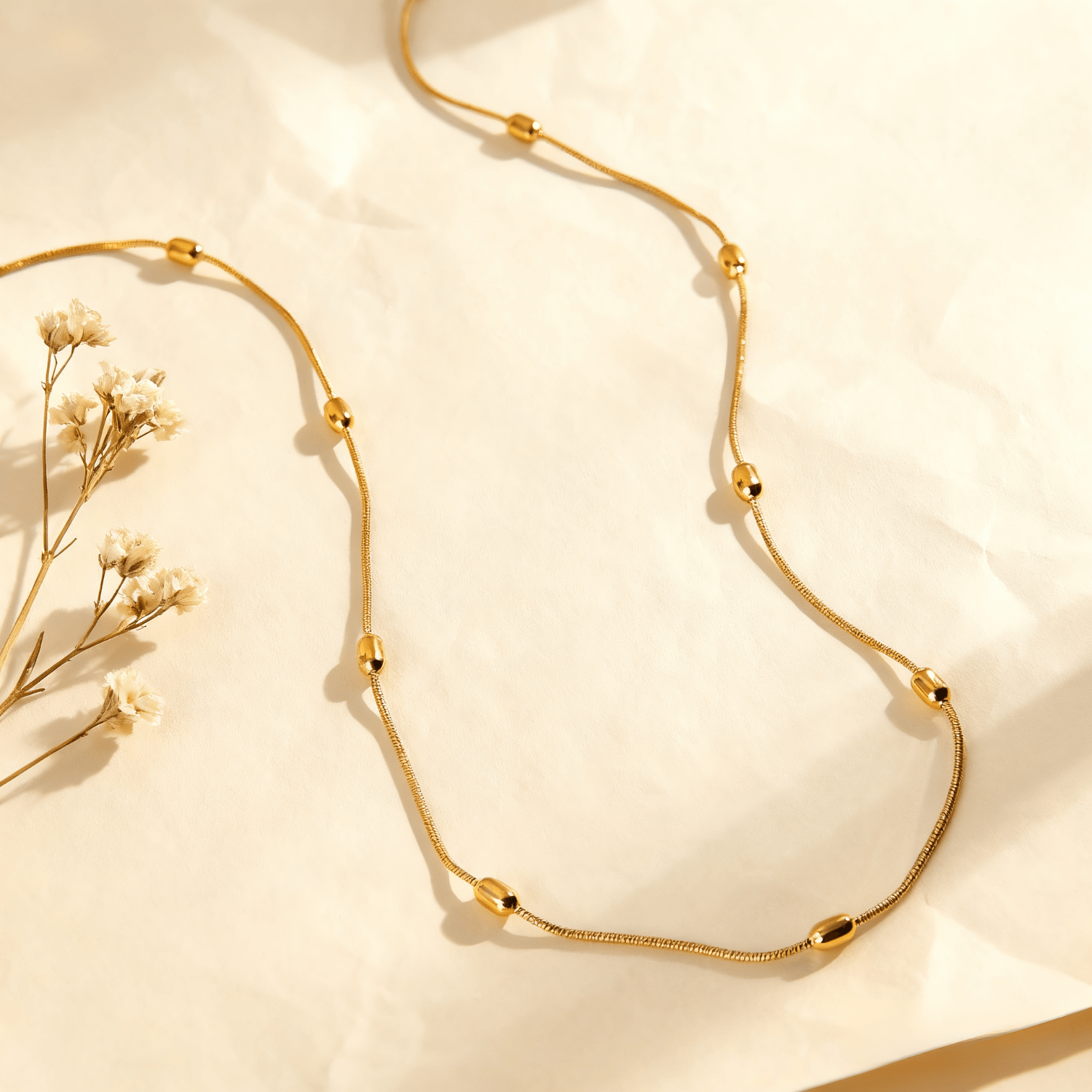 Luminova Dainty Beaded Gold Chain Necklace isolated on a white gold background, showcasing the textured bead design.