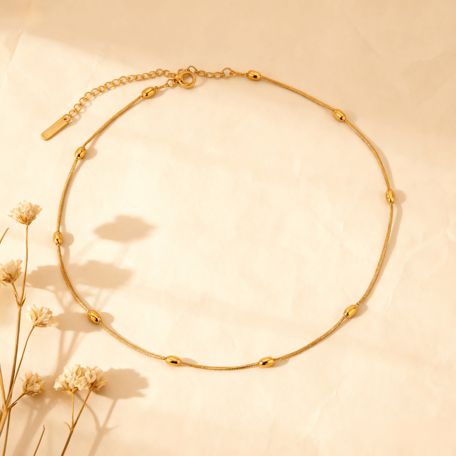 Luminova Dainty Beaded Gold Chain Necklace isolated on a white gold background, showcasing the textured bead design.