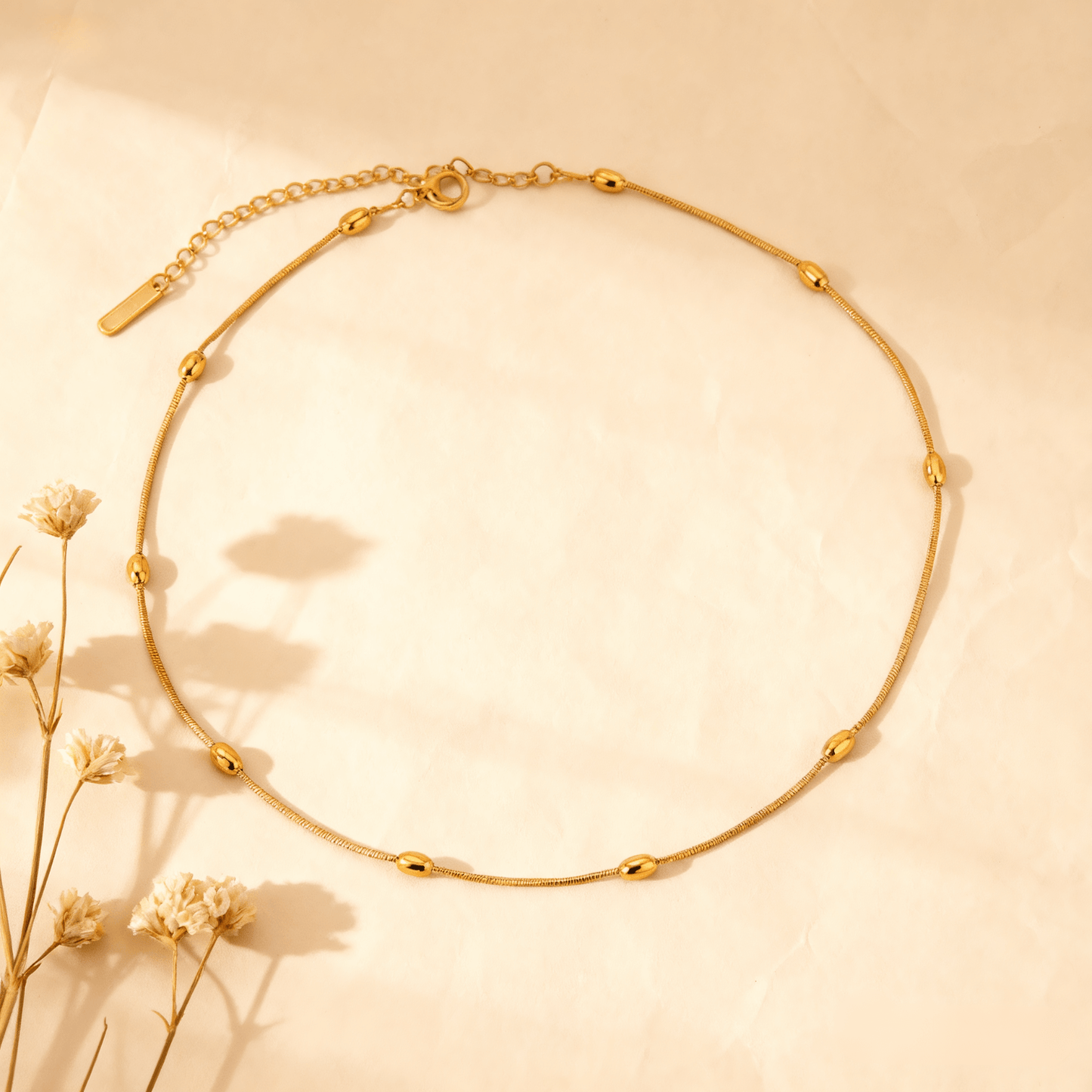 Luminova Dainty Beaded Gold Chain Necklace isolated on a white gold background, showcasing the textured bead design.