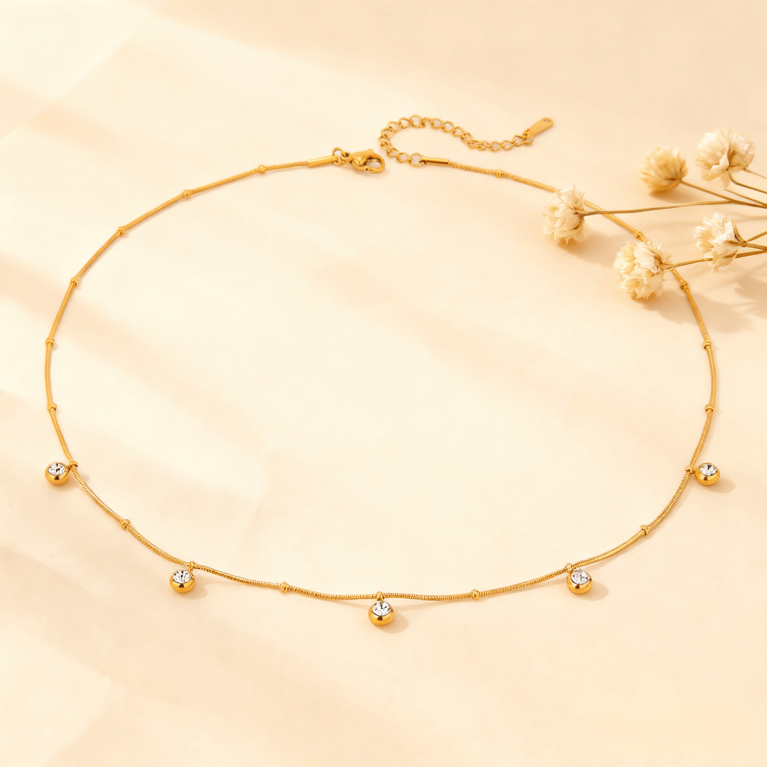 Luminova Dainty Gold Drop Necklace with a teardrop pendant, isolated on a white background.