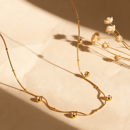 Luminova Dainty Gold Drop Necklace with a teardrop pendant, isolated on a white background.