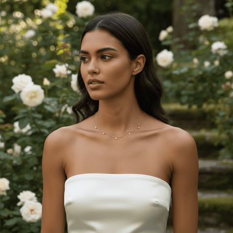 Side-profile of a woman wearing the Dainty Drop Necklace, the pendant gracefully swaying against the skin.